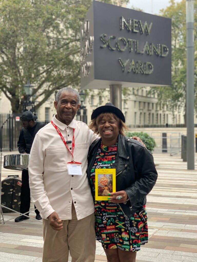 ALEX PASCALL OBE OUTSIDE SCOTLAND YARD WITH LONG STANDING STAFF MEMBER